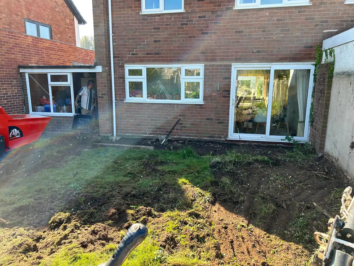 Rear of a Wombourne semi-detached house before the extension, with lawn and patio doors