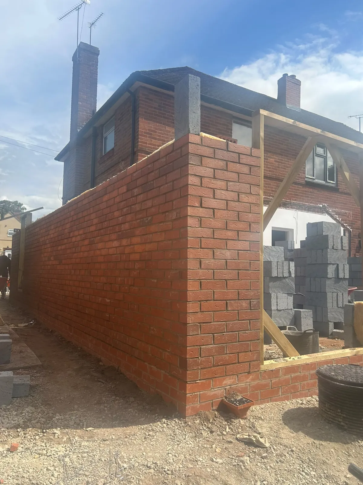 New brickwork rising with temporary frames above