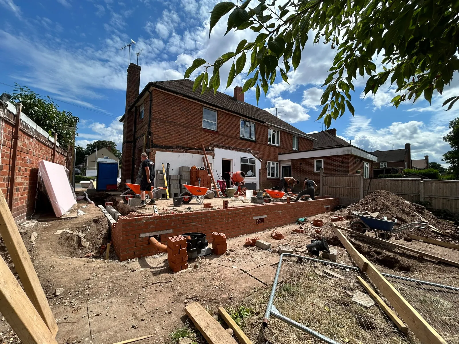 Wide view of the footings and low walls across the rear of the house