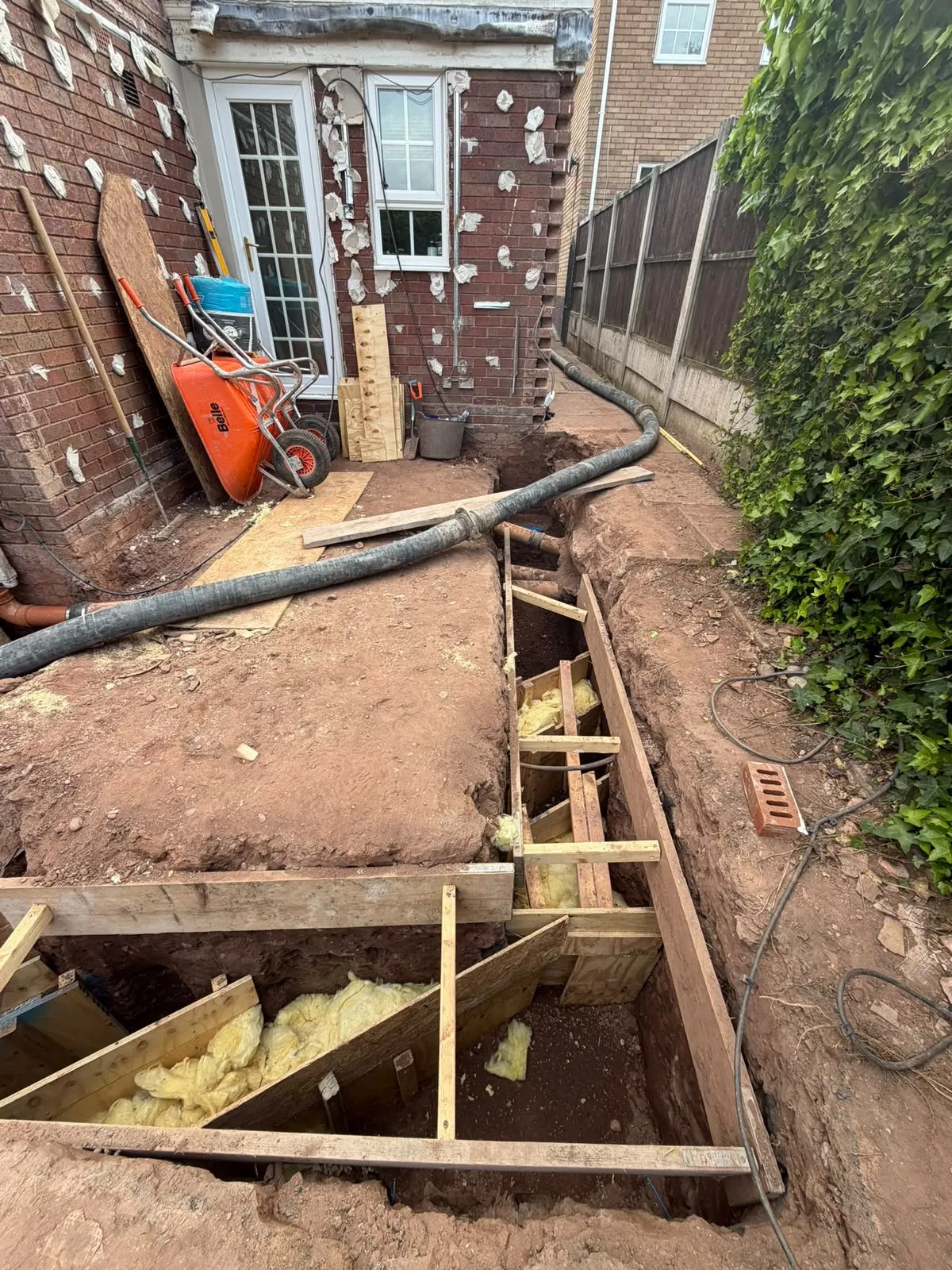 Formwork and insulated footings beside the rear wall of the house