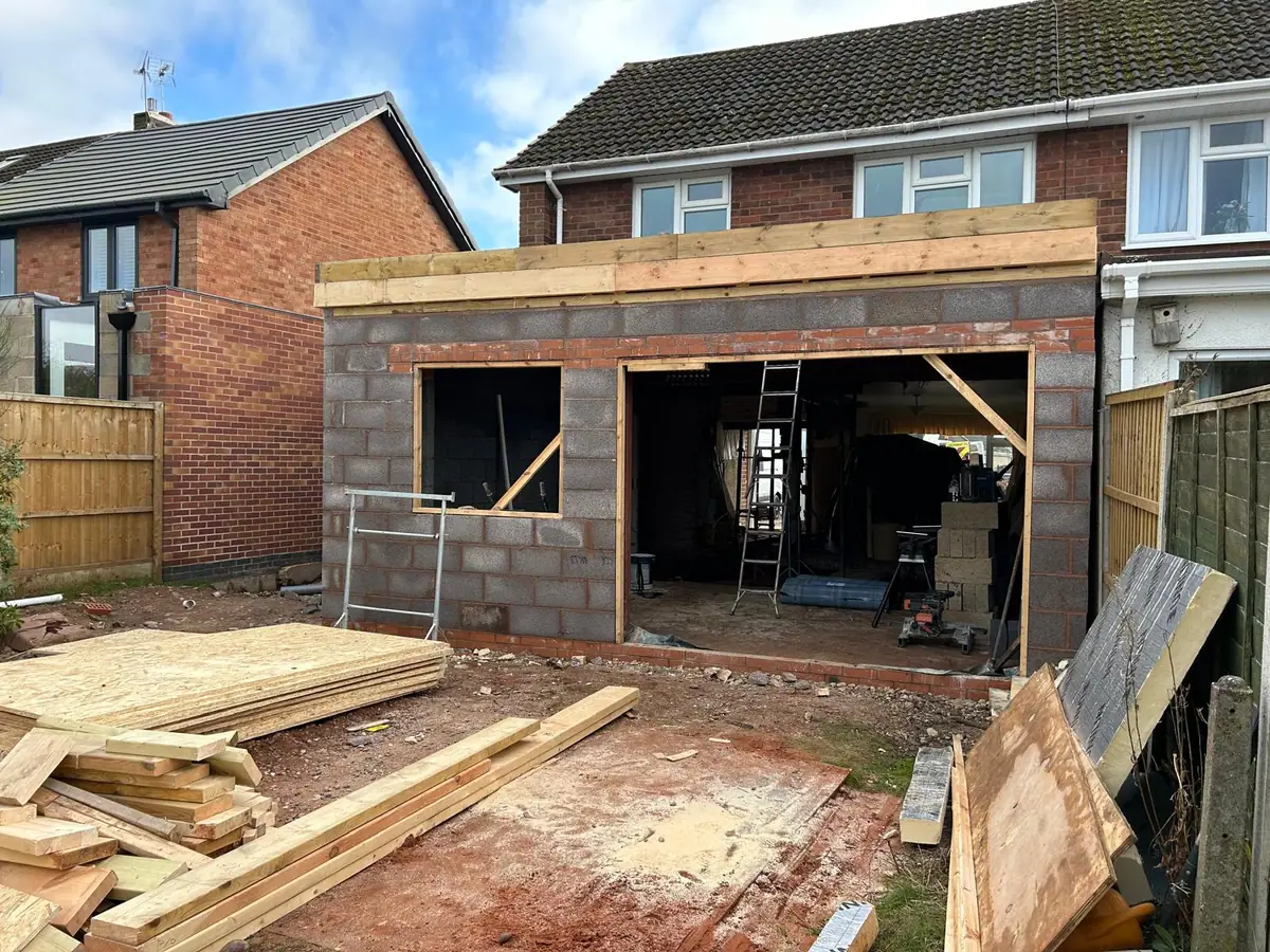 Completed extension blockwork shell with window openings and timber wall plate