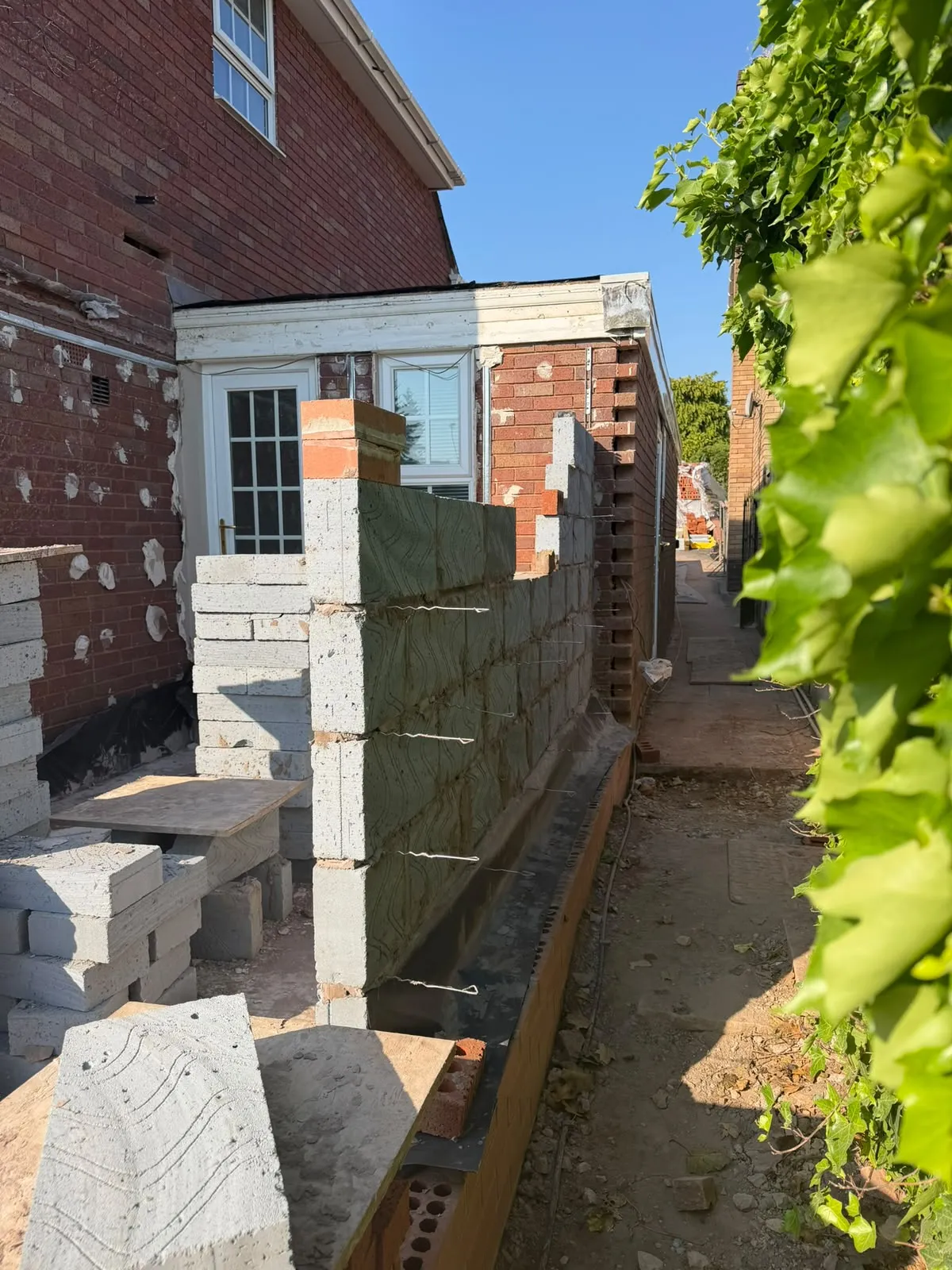 Blockwork and brick rising along the side elevation