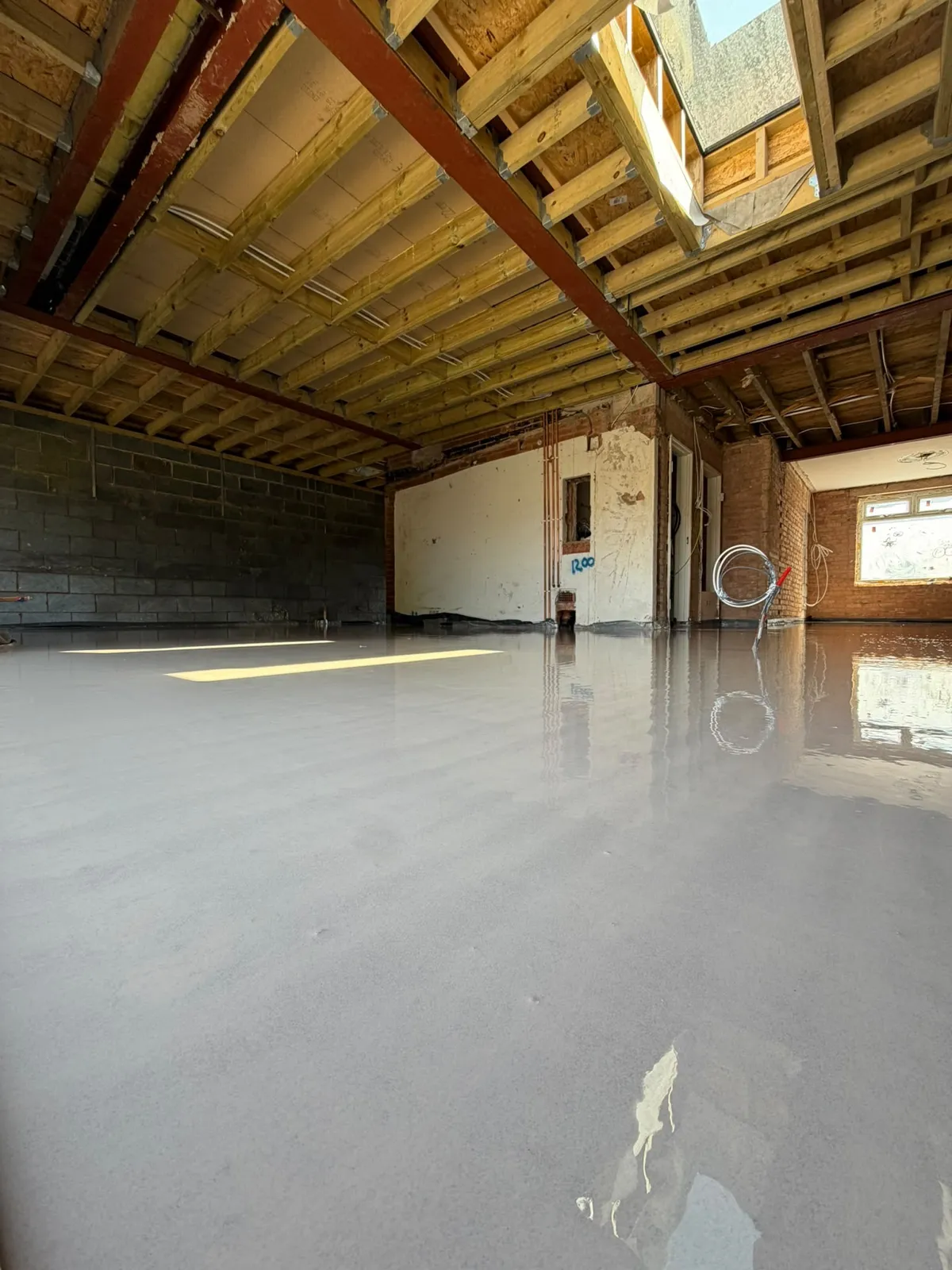 Liquid screed flowing across the open-plan ground floor