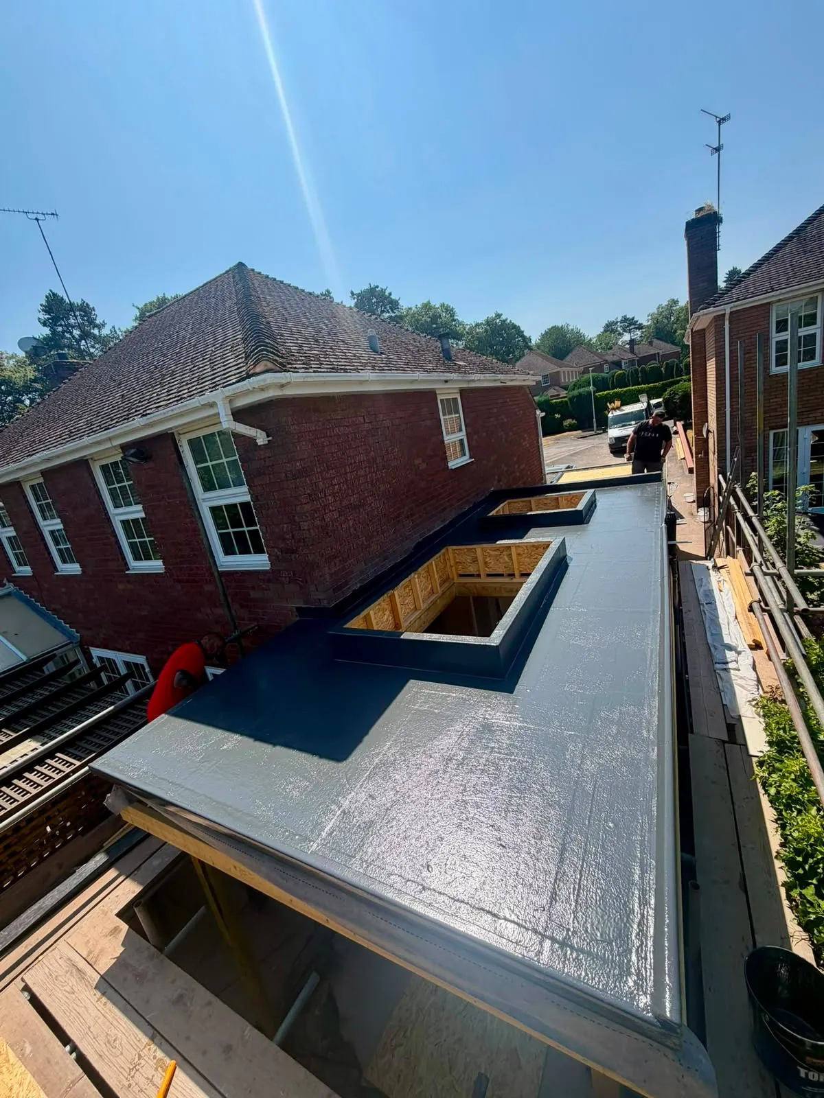 Finished flat roof with skylight kerbs, seen from the scaffold