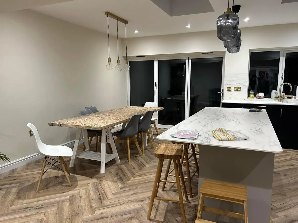Finished open-plan kitchen diner with herringbone flooring in a Wombourne home extension